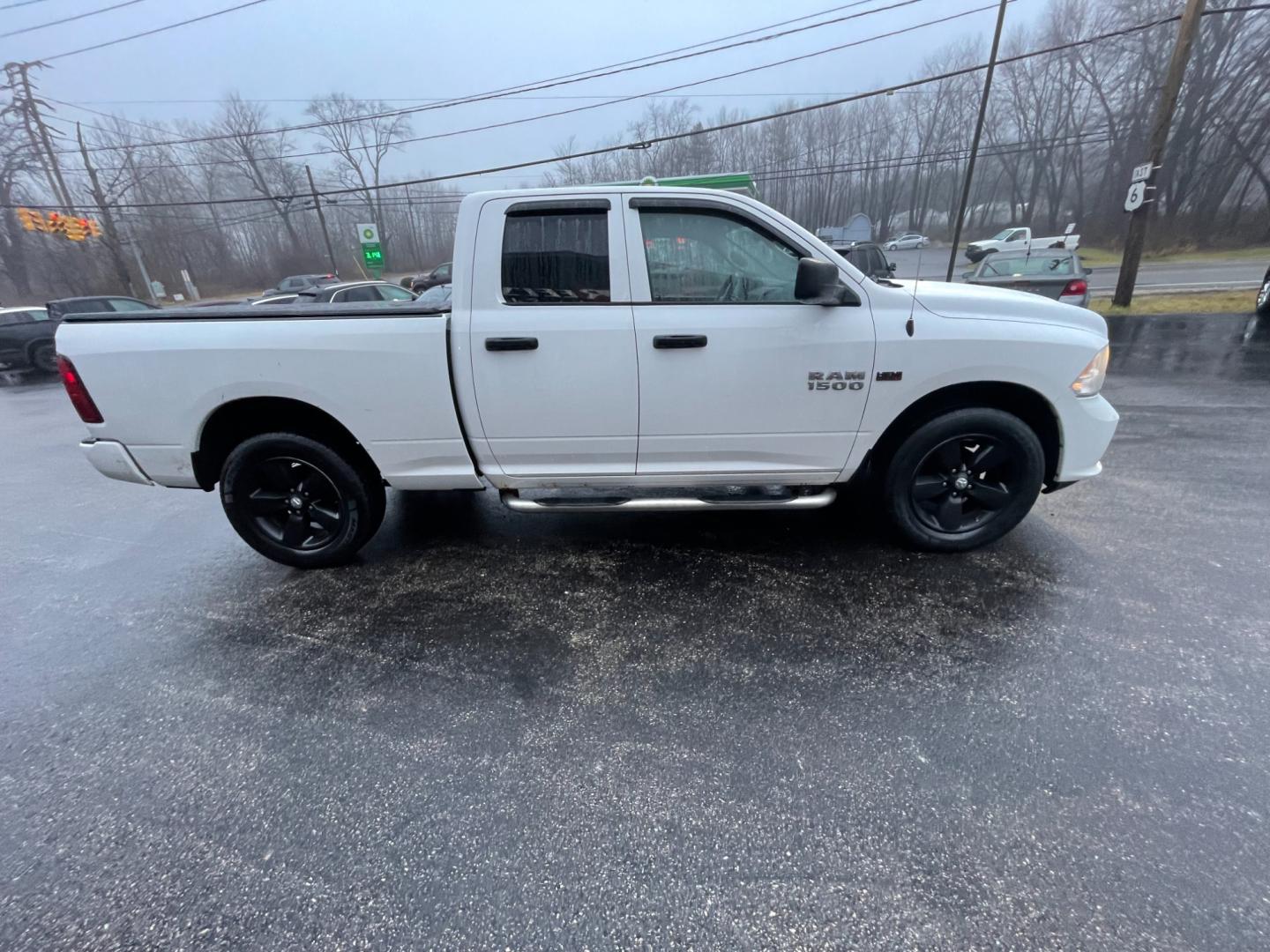 2014 White /Black RAM 1500 Express Quad Cab 4WD (1C6RR7FT5ES) with an 5.7L V8 OHV 16V engine, 8-Speed Automatic transmission, located at 11115 Chardon Rd. , Chardon, OH, 44024, (440) 214-9705, 41.580246, -81.241943 - Photo#7